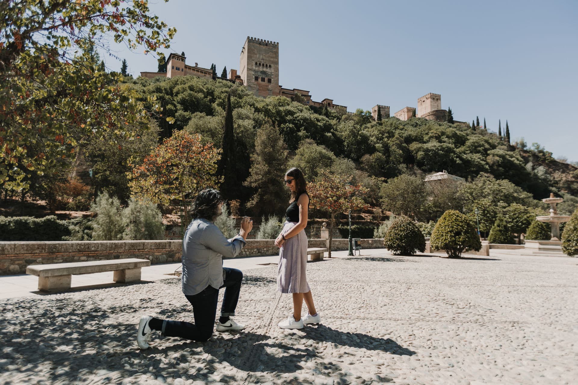 Romantic proposal scene at Alhambra palace in Granada Spain at sunset